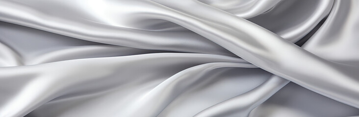 Fototapeta premium A background resembling folds on silver silk satin fabric, providing an elegant and luxurious backdrop. This sophisticated texture evokes a sense of opulence and refinement, perfect for use