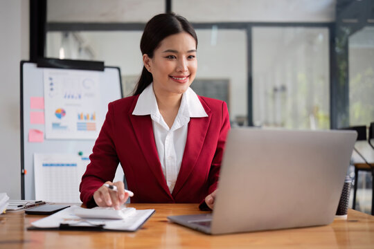Business woman using calculator for do math finance on wooden desk in office and business working background, tax, accounting, statistics and analytic research concept
