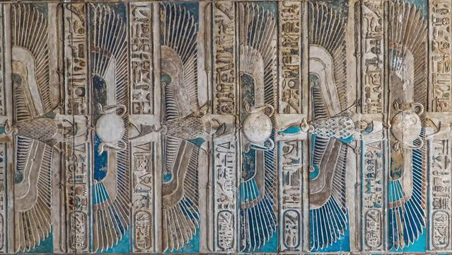 Ancient Egyptian hieroglyphs and bas-reliefs close-up in Dendera temple or Temple of Hathor. Egypt. Dendera Temple complex, one of the best-preserved temple sites from ancient Upper Egypt.