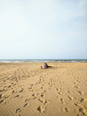 Obraz premium By the Ocean's Edge: Bonding Moments with Mother, Son and Dog