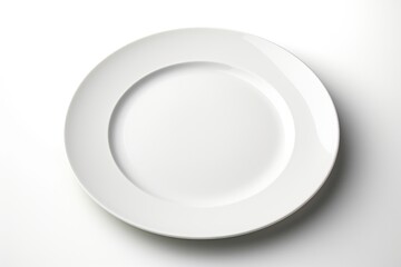 A simple white plate on a white table, ideal for food photography