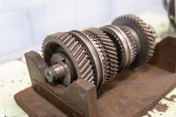 A gearbox consisting of several gears of different sizes on a workbench