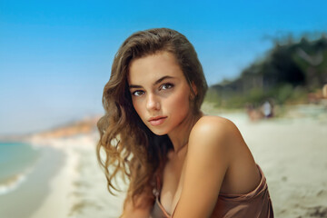 Close up of young woman vacationing at the beach with blurred background. - 758880984