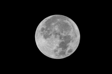 Full moon over dark black sky at night