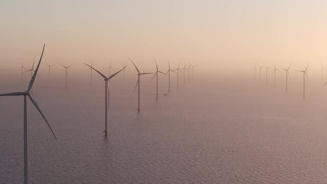 Aerial view of ship cruising in sea at Windpark Friesland at dawn, Netherlands