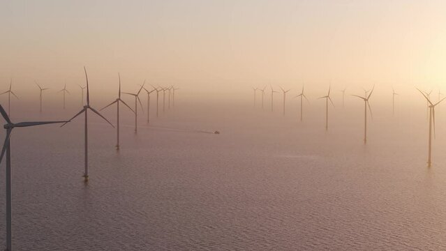 Aerial view of ship cruising in sea at Windpark Friesland at dawn, Netherlands