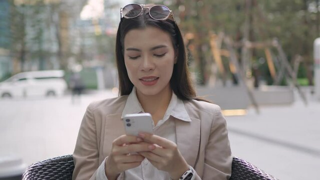 Beautiful white businesswoman using smart phone send text message or e-mail.