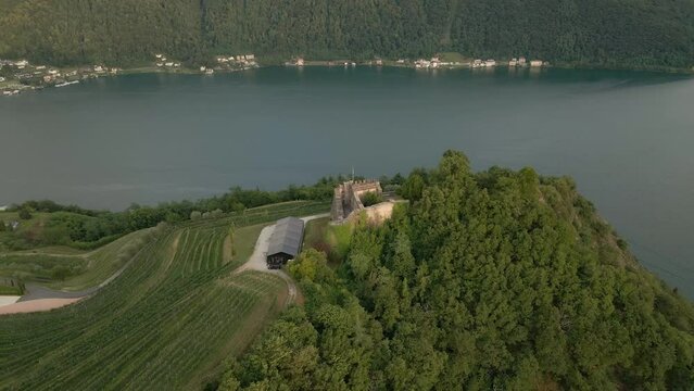 Aerial view of castle (Castello di Morcote) in Morcote with vineyard and mountain View during sunset, Lake Lugano, Switzerland
