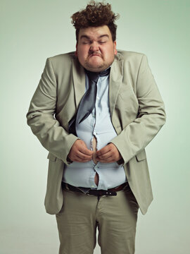 Overweight, portrait and man fitting in shirt, studio and employee with stomach for clothes. Plus size, male person and guy with obesity unhappy with fat of belly in suit for professional job