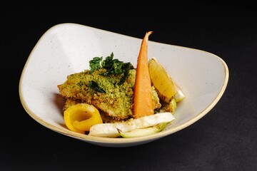 Delicious and Healthy Baked Fish with Carrot and Zucchini on a Plate with Lemon Wedge