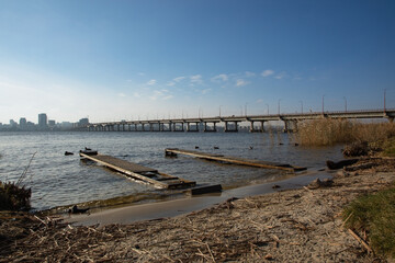 Dnipro river, Dnipro city, Ukraine. Cityscape with blue sky with clouds and river, and city...