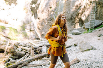 Young woman with backpacks and walking sticks hiking in nature. Adventure, travel, tourism, hike and people concept.