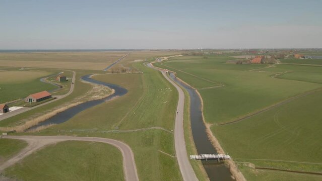 Aerial view of dutch countryside with cyclists at summer, Netherlands
