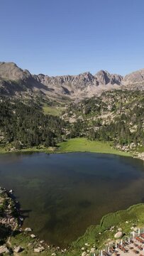 Aerial view of beautiful mountainous landscape with clear lake and green vegetation, Encamp, Andorra.