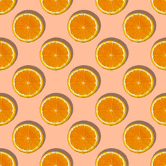 Uniform pattern of orange slices with shadow on peach trendy background. Flat layout