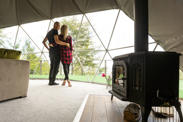 a couple dancing in geo dome tents.