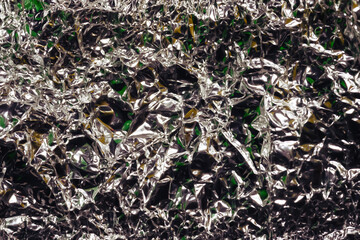 Glaring surface. Wrinkled foil. Crumpled background