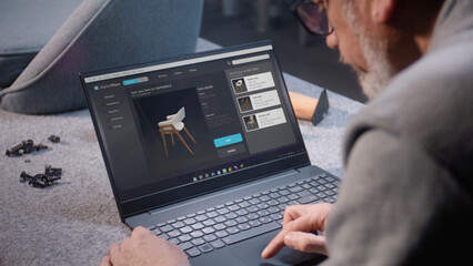 Small business owner uploads pictures of stylish wooden chair to online store website using laptop. Craftsman adds photos of his product to the internet marketplace for sale. Entrepreneurship concept.
