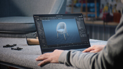 Creative man uses professional software for furniture design creation and 3D modeling working on laptop computer. Designer creates digital 3D model of stylish wooden chair, prepares carpentry project.