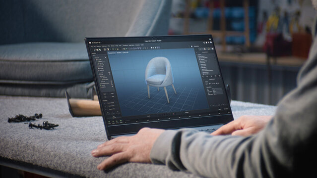 Creative man uses professional software for furniture design creation and 3D modeling working on laptop computer. Designer creates digital 3D model of stylish wooden chair, prepares carpentry project.
