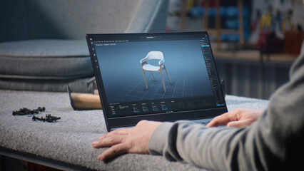Creative man uses professional software for furniture design creation and 3D modeling working on...