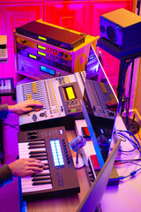 male music producer hands working on professional audio equipment in recording studio. music...