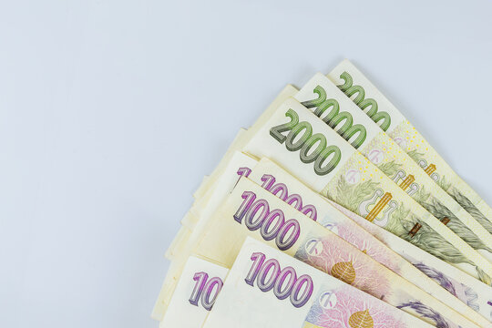 Different value stacked money bills of Czech Republic koruna CZK banknotes cash currency at white background