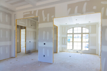 Building new home with gypsum plaster walls drywall that has been finished in preparation for...