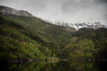 Fototapeta na wymiar Snow peaked mountains in the fjords of Norway