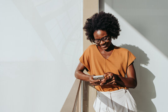 Business woman using a smartphone for workplace connectivity