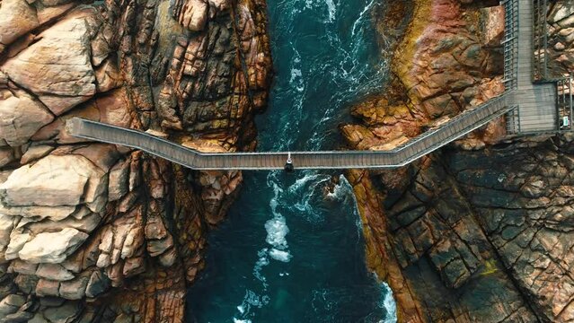 Aerial view of Canal Rocks, Yallingup with coastal bridge and vibrant waves, Western Australia.