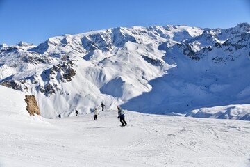 Skiers on the slopes of Courchevel ski resort, French alps.
