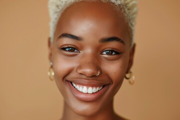 A young woman with a shaved head smiling. Suitable for lifestyle and beauty concepts