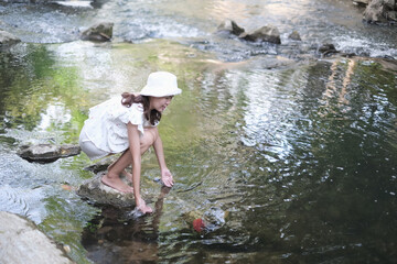 portrait asian woman relax in tropical nature near stream