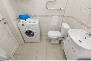 modern bathroom room with toilet and washing machine