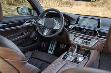 Shift lever, car steering wheel and sensors. Inside a modern car view, city car interior background