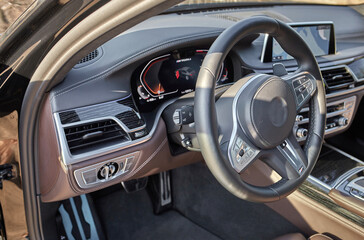 Shift lever, car steering wheel and sensors. Inside a modern car view, city car interior background