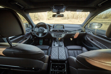 Fototapeta premium Inside moden car background, luxury car interior elements wallpaper. Black leather car interior