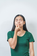 Happy and calm Asian girl is seen enjoying a pleasant aroma, taking deep breaths of fresh air in isolation.