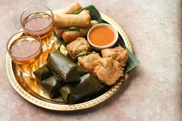 Lontong and Gorengan. Indonesia traditional snack very popular during ramadan for iftar served with hot tea. Iftar concept for Ramadan Kareem. 