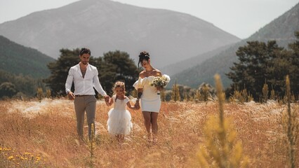 Capturing the beauty of love and family with stunning outdoor photograph featuring a young married...