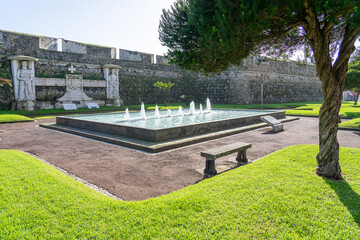 water fountain in the Francisco Borges da Silva garden next to the walls of the São Braz fort in...