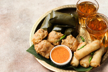 Lontong and Gorengan. Indonesia traditional snack very popular during ramadan for iftar served with hot tea. Iftar concept for Ramadan Kareem. 