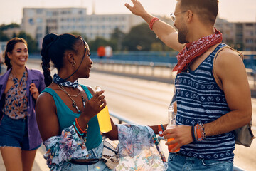 Multiracial couple of festival goers having fun in summer day.