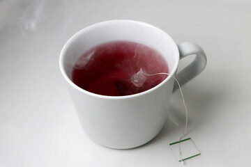 red hot tea in a beautiful mug on a white background