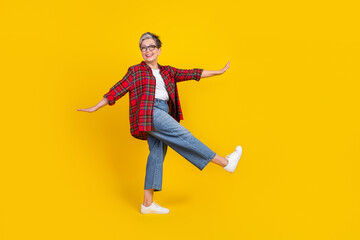 Fototapeta na wymiar Full length profile photo of cheerful pretty lady chilling dancing empty space isolated on yellow color background