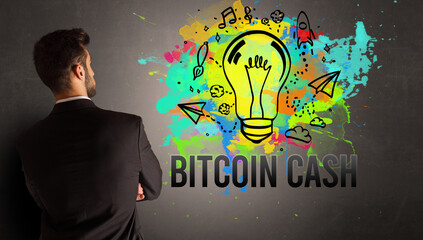 businessman drawing colorful light bulb