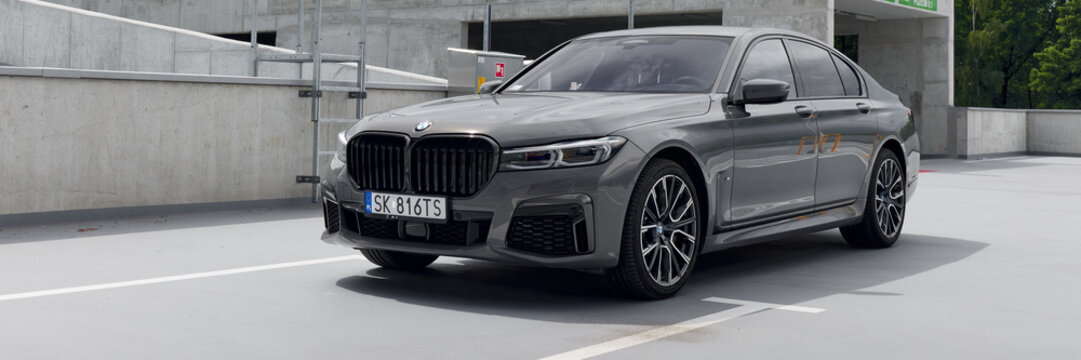 Luxurious gray BMW 740D, G12 model, parked in an empty parking lot. Cloudy day. No other car and people. Katowice, Poland, 12.06.2021