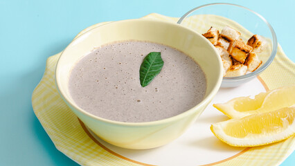 Creamy mushrooms soup bowl isolated