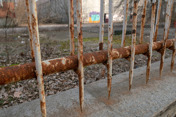 old rusty fence, with signs of age and neglect, work to remove the rust, and apply anti-rust and new paint